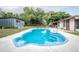 View of the pool, outbuilding, and fenced in yard at 800 Jefferis Ct, Eustis, FL 32726