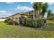 Screened lanai in backyard with outdoor seating, tropical landscaping and room for entertaining at 802 San Salvador Dr, The Villages, FL 32159