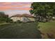 Green backyard featuring mature trees, lush lawn, and view of the home's rear exterior at 802 San Salvador Dr, The Villages, FL 32159