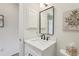 Bright bathroom featuring a marble countertop and stylish black faucet with an updated white vanity at 802 San Salvador Dr, The Villages, FL 32159