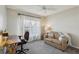 Cozy bedroom with a ceiling fan, desk, and comfortable couch; perfect for an office or relaxation space at 802 San Salvador Dr, The Villages, FL 32159