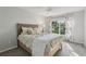 The bedroom has a ceiling fan, large window, and neutral wall-to-wall carpeting at 802 San Salvador Dr, The Villages, FL 32159
