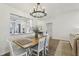 Inviting dining room features a rustic wood table and modern chandelier at 802 San Salvador Dr, The Villages, FL 32159