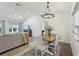 Charming dining room with modern light fixture is open to the living area at 802 San Salvador Dr, The Villages, FL 32159