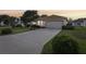 Well-maintained single-story home with long driveway, lush lawn, and attached two-car garage at 802 San Salvador Dr, The Villages, FL 32159
