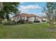 Attractive single-story home featuring lush landscaping, well-maintained lawn, and a neutral color scheme at 802 San Salvador Dr, The Villages, FL 32159
