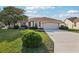 Charming single-story home features a well-manicured lawn, two-car garage, and inviting curb appeal at 802 San Salvador Dr, The Villages, FL 32159