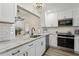 This renovated kitchen features white subway tile backsplash and updated appliances at 802 San Salvador Dr, The Villages, FL 32159