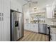 Updated kitchen with stainless steel appliances, white cabinets and granite countertops at 802 San Salvador Dr, The Villages, FL 32159