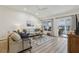 Bright living room with vaulted ceilings offers a sliding glass door to an outdoor patio at 802 San Salvador Dr, The Villages, FL 32159