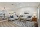 Bright living room features vaulted ceilings, two sofas, ceiling fan and neutral color palette at 802 San Salvador Dr, The Villages, FL 32159