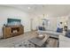 Open living room boasts vaulted ceiling, wood flooring, comfortable furnishings, and lots of natural light at 802 San Salvador Dr, The Villages, FL 32159