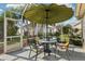 Charming screened patio with an umbrella-covered table and comfortable seating, surrounded by lush greenery at 802 San Salvador Dr, The Villages, FL 32159