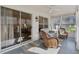 Bright sunroom featuring a ceiling fan, sliding glass doors, comfortable seating, and ample sunlight at 802 San Salvador Dr, The Villages, FL 32159