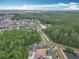 A scenic aerial view of the community showcasing lush greenery, a pond, and well-maintained homes under a partly cloudy sky at 8530 Vivaro Isle Way, Windermere, FL 34786