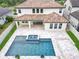 Aerial view of the house, showcasing the tile roof, covered patio, and backyard pool at 8530 Vivaro Isle Way, Windermere, FL 34786