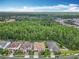 Aerial view of home surrounded by lush greenery, showcasing its serene and private location at 8530 Vivaro Isle Way, Windermere, FL 34786