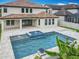 Backyard features a pool with spa and fountain and access to the home's covered patio at 8530 Vivaro Isle Way, Windermere, FL 34786