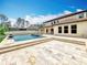 Luxury backyard featuring a swimming pool, covered patio, and a spacious travertine deck at 8530 Vivaro Isle Way, Windermere, FL 34786