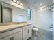 Modern bathroom featuring shower over tub, granite countertops, and neutral vanity at 8530 Vivaro Isle Way, Windermere, FL 34786