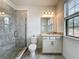 Bathroom featuring a granite vanity, tile flooring, and a glass-enclosed shower for a clean and modern feel at 8530 Vivaro Isle Way, Windermere, FL 34786