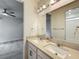 Bathroom featuring double sinks, granite countertops, and neutral colored vanity at 8530 Vivaro Isle Way, Windermere, FL 34786