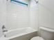Bright bathroom featuring shower over tub and large white tiles at 8530 Vivaro Isle Way, Windermere, FL 34786