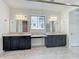 Bathroom with double vanities, granite counters, large mirrors, and a connecting door leading to another room at 8530 Vivaro Isle Way, Windermere, FL 34786