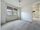 A bright bedroom with two windows, decorative blinds, carpet flooring and an overhead light fixture at 8530 Vivaro Isle Way, Windermere, FL 34786
