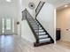 Stunning entryway showcases staircase with iron spindles and elegant front door at 8530 Vivaro Isle Way, Windermere, FL 34786