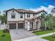 Stunning two-story home featuring a tile roof, brick accents, and a paver driveway at 8530 Vivaro Isle Way, Windermere, FL 34786