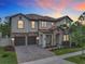 Stunning two-story home featuring a tile roof, brick accents, and a paver driveway at 8530 Vivaro Isle Way, Windermere, FL 34786