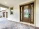 Elegant front door with decorative glass, sidelights, and a brick paver entryway at 8530 Vivaro Isle Way, Windermere, FL 34786