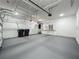 Spacious garage with ample overhead storage racks and workbench with storage at 8530 Vivaro Isle Way, Windermere, FL 34786