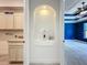 Elegant hallway niche with decorative lighting, connecting to the laundry and a bedroom with blue accent wall at 8530 Vivaro Isle Way, Windermere, FL 34786