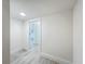 A bright hallway features wood-style flooring and an open doorway leading to a bright room at 8530 Vivaro Isle Way, Windermere, FL 34786