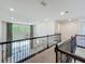 A brightly lit hallway offers views to an open space with large windows and decorative curtains at 8530 Vivaro Isle Way, Windermere, FL 34786