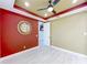 Inviting office space features a mirror, ceiling fan, and an adjacent room entrance at 8530 Vivaro Isle Way, Windermere, FL 34786