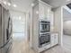 Modern kitchen boasts stainless steel double ovens and tile flooring at 8530 Vivaro Isle Way, Windermere, FL 34786
