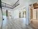 Spacious living area with coffered ceilings, tile floors, flowing into kitchen and dining spaces at 8530 Vivaro Isle Way, Windermere, FL 34786