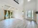 Bright living room with coffered ceiling, large windows, and stylish tile flooring at 8530 Vivaro Isle Way, Windermere, FL 34786