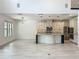 Bright and airy living space with modern kitchen, spacious layout, and stylish tile flooring at 8530 Vivaro Isle Way, Windermere, FL 34786