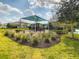 Community playground featuring shaded play structures, a slide, and seating area, surrounded by lush landscaping at 8530 Vivaro Isle Way, Windermere, FL 34786