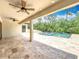 Covered patio boasts recessed lighting and a view of the sparkling pool with fountain feature at 8530 Vivaro Isle Way, Windermere, FL 34786