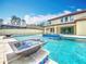 Swimming pool with fountain and modern water feature against blue skies at 8530 Vivaro Isle Way, Windermere, FL 34786