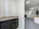 A utility area features granite counters and cabinets with a view into an oversized garage at 8530 Vivaro Isle Way, Windermere, FL 34786