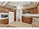 A stylish kitchen has dark wood cabinetry, stainless steel appliances, and neutral countertops at 8709 Sw 96Th St # A, Ocala, FL 34481