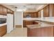 Updated kitchen featuring wood cabinets, stainless steel appliances, and neutral granite countertops at 8709 Sw 96Th St # A, Ocala, FL 34481