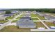 This aerial view showcases the property with a boat in the fenced backyard in a neighborhood setting at 8978 Se 42Nd Ct, Ocala, FL 34480