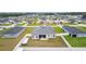Drone shot of the property showing solar panels and the home with fenced-in backyard in a neighborhood setting at 8978 Se 42Nd Ct, Ocala, FL 34480